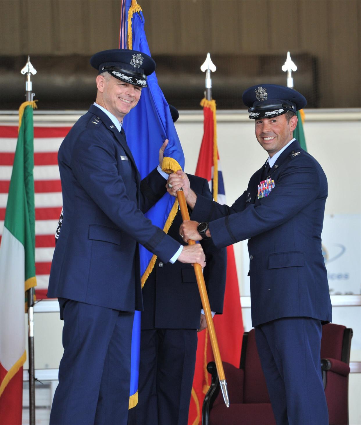 Major General Craig Wills 19th Air Force Commander (left) stands with Colonel Brad Orgeron in handing off the 80th Flying Training Wing flag during the 80th Flying Training Wing Change of Command ceremony at Sheppard Air Force Base in Wichita Falls on Friday, June 24, 2022.