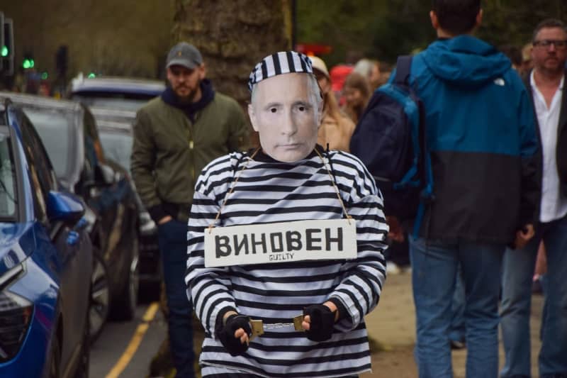 A protester dressed as Russian President Vladimir Putin in prison garb and handcuffs stands outside the Russian embassy as Russian citizens line up to cast their votes for the presidential election.  Vuk Valcic/ZUMA Press Wire/dpa