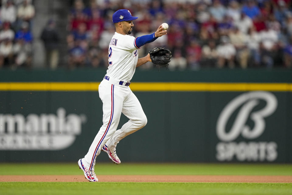 Texas Rangers second baseman Marcus Semien throws Arizona Diamondbacks' Corbin Carroll out at first during the first inning in Game 2 of the baseball World Series Saturday, Oct. 28, 2023, in Arlington, Texas. (AP Photo/Brynn Anderson)