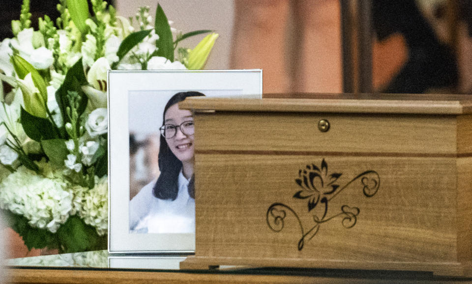 This photo shows a box containing some of Yingying Zhang's possessions, and a photo of her during a memorial service, Friday, Aug. 9, 2019 at the First Baptist Church in Savoy, Ill. The family of Yingying Zhang, a Chinese scholar whose body was never recovered after her 2017 slaying gathered at a memorial service that included only her photograph and their own memories of her life. (Robin Scholz/The News-Gazette via AP)