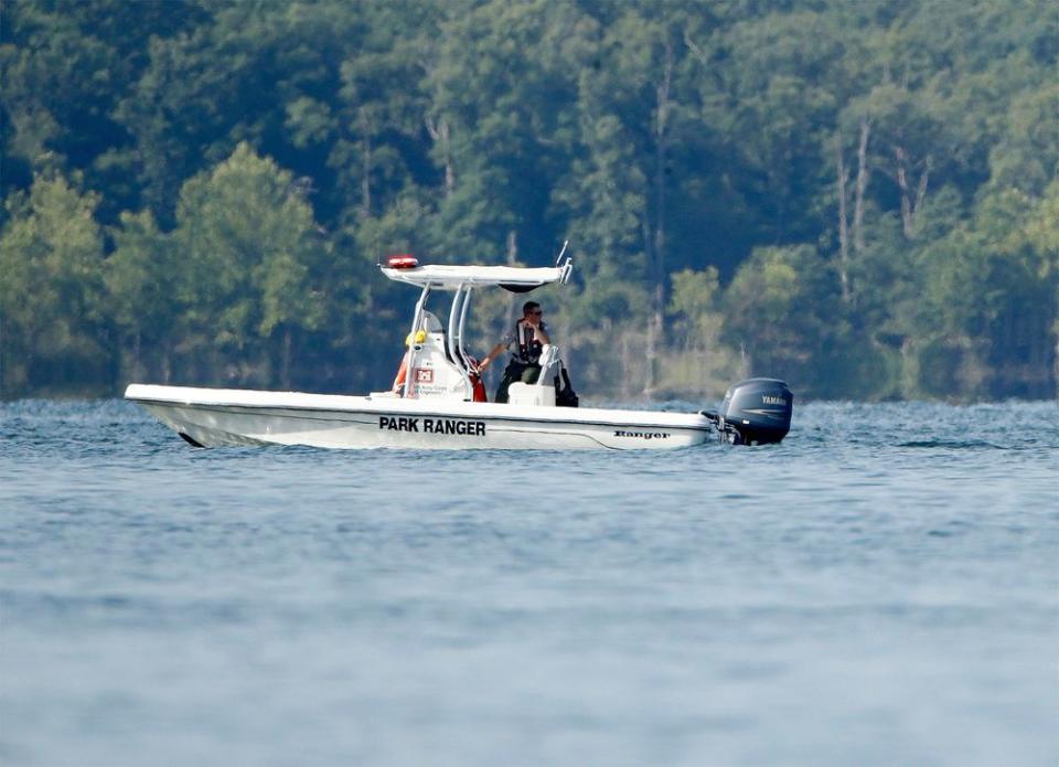 A park ranger patrols an area on Friday, near where a duck boat capsized in Table Rock Lake