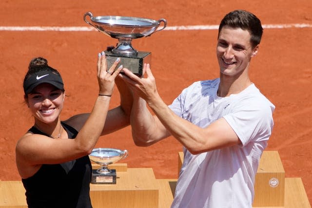 Joe Salisbury, right, and Desirae Krawczyk hold the mixed doubles trophy aloft