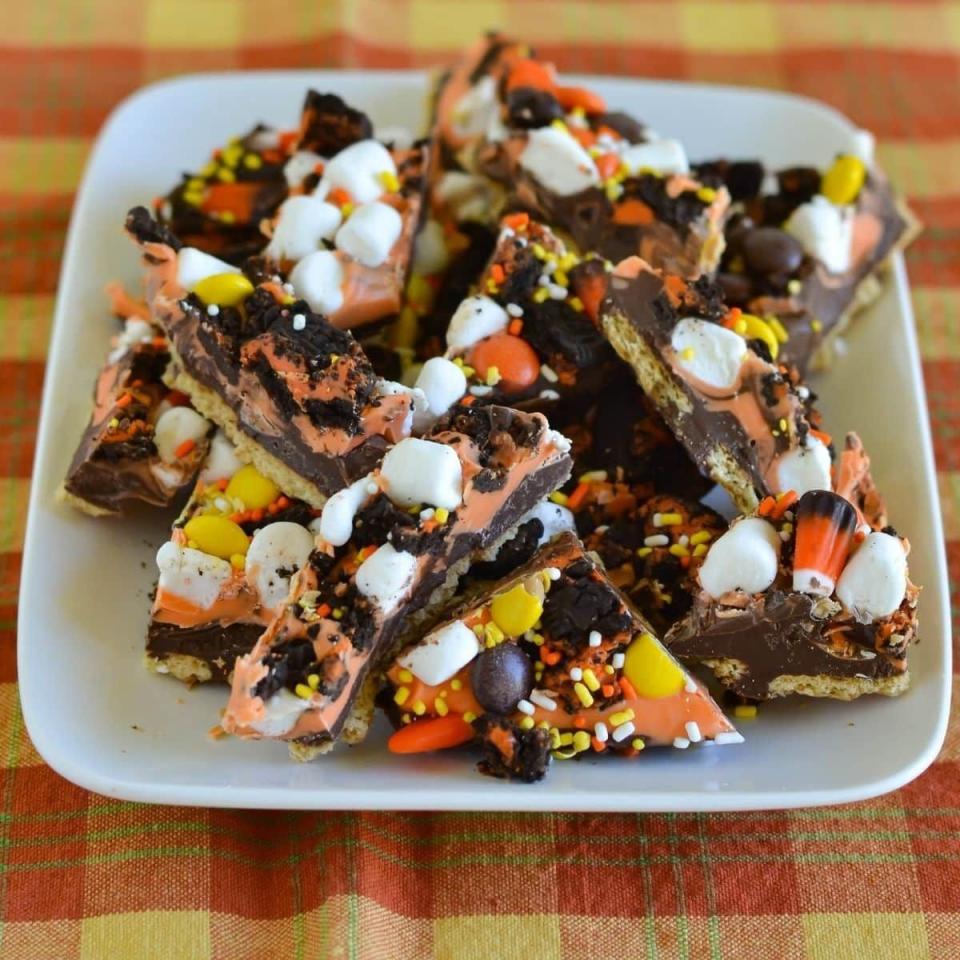 <p>This easy bark recipe combines Oreos with Reese's Pieces, mini marshmallows, sprinkles, and candy corn for an all-out Halloween snack.</p><p>Get the <strong><a href="https://flouronmyface.com/halloween-cookie-bark/" rel="nofollow noopener" target="_blank" data-ylk="slk:Halloween Cookie Bark recipe;elm:context_link;itc:0;sec:content-canvas" class="link ">Halloween Cookie Bark recipe</a></strong> at Flour On My Face.</p>
