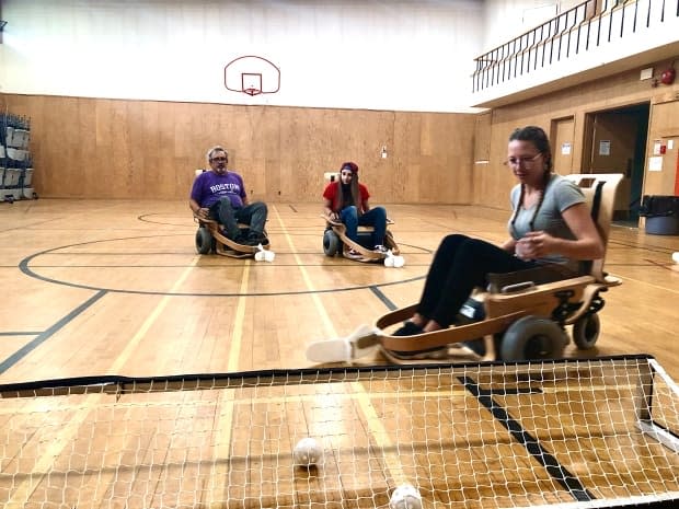 Volt hockey is a type of floor hockey geared towards young players with mobility difficulties, such as muscular dystrophy and cerebral palsy. The coaches at the children’s charity Variety Alberta tested the new chairs last week at the Kirk United Church Centre in Edmonton.   (Liam Harrap/CBC Edmonton  - image credit)