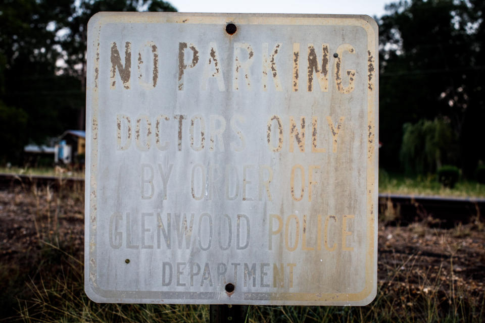 Weathered parking signs posted outside the shuttered Lower Oconee Community Hospital in Glenwood.