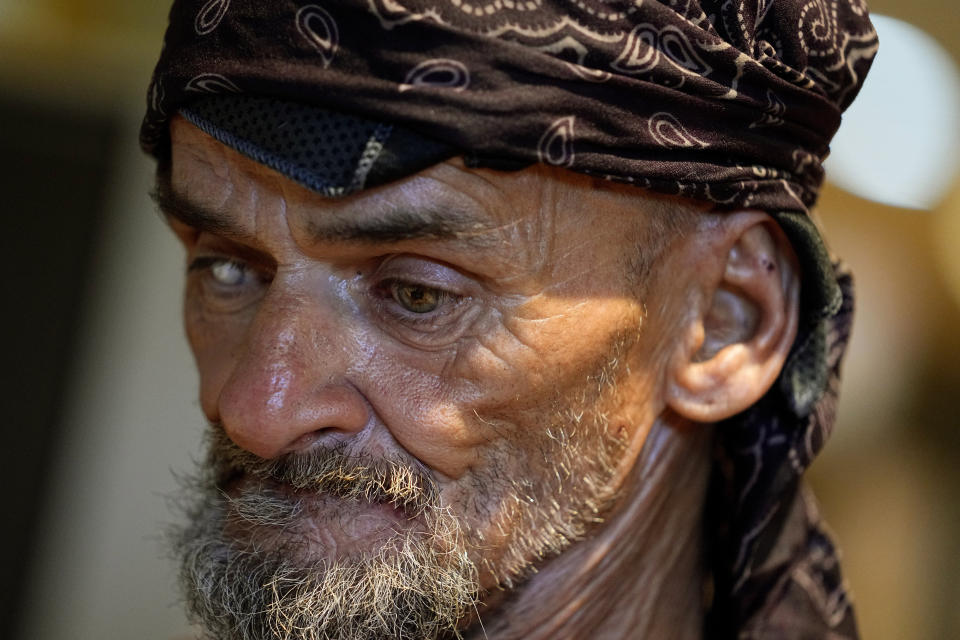 Charles Sanders, 59, cools off inside the Justa Center, Friday, July 14, 2023, in downtown Phoenix. Sanders, from Denver, has been spending the days at the center, a day center for homeless people 55 years and older in the downtown area. Several dozen people stop by daily for cold water, a meal, a shower and an electrical outlet to charge a mobile phone. (AP Photo/Matt York)