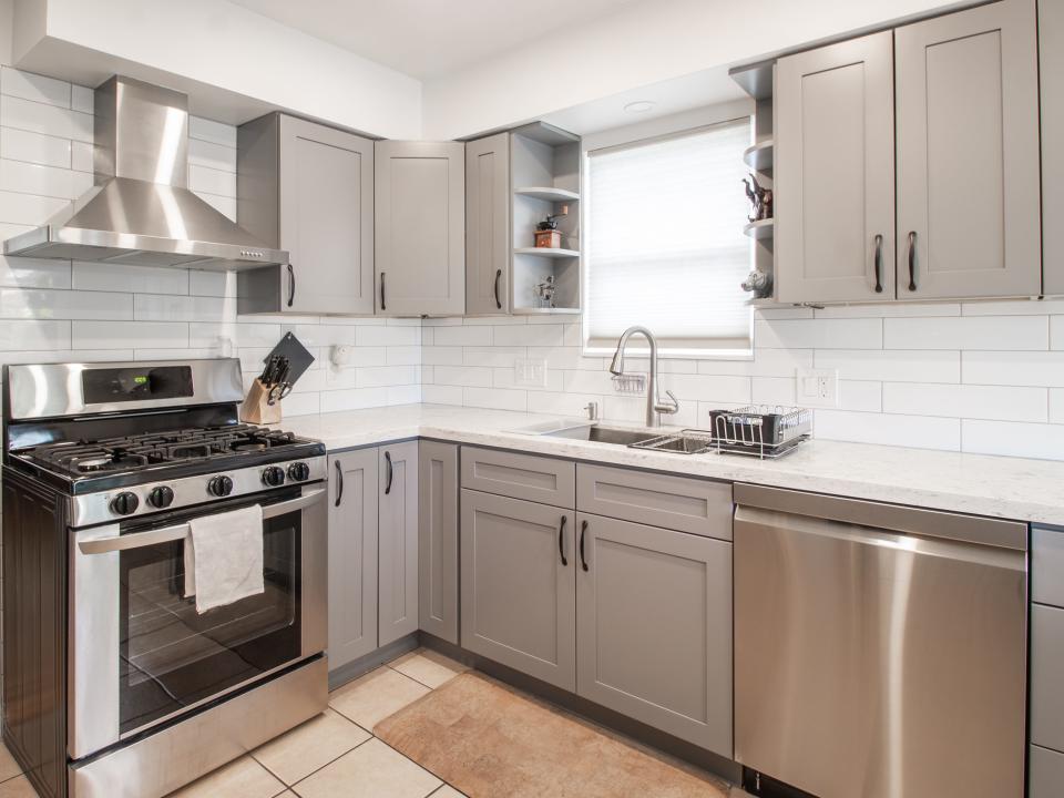 A kitchen with gray cabinets