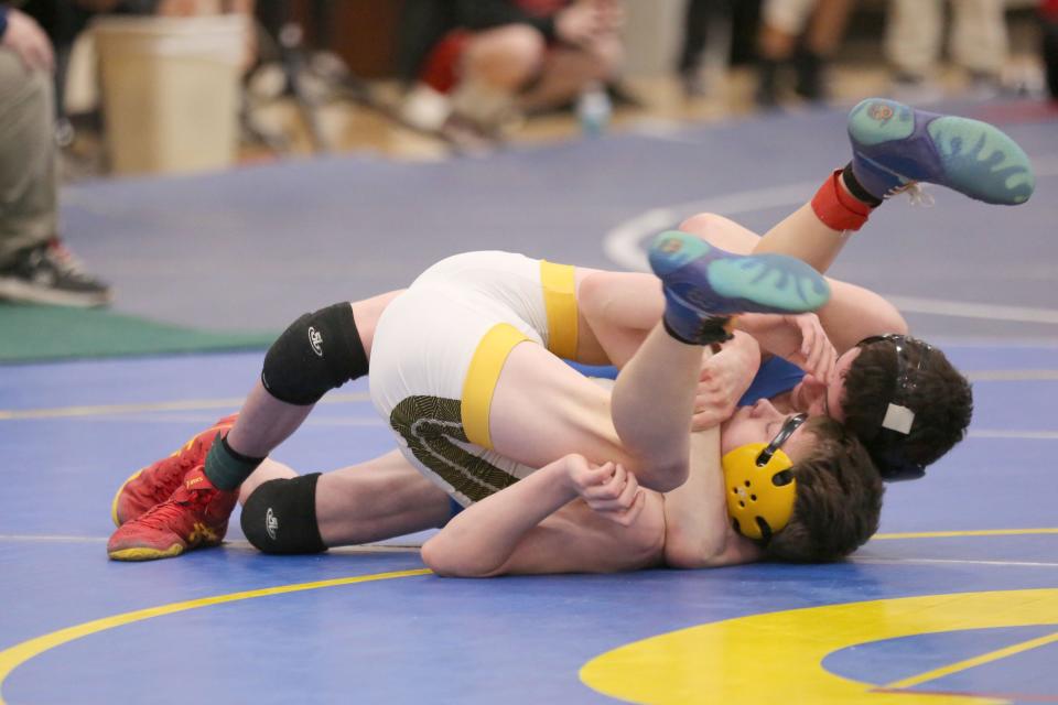 Clyde's Heath Norris controls Woodmore's Wyatt Thieroff in a 106 pound match.