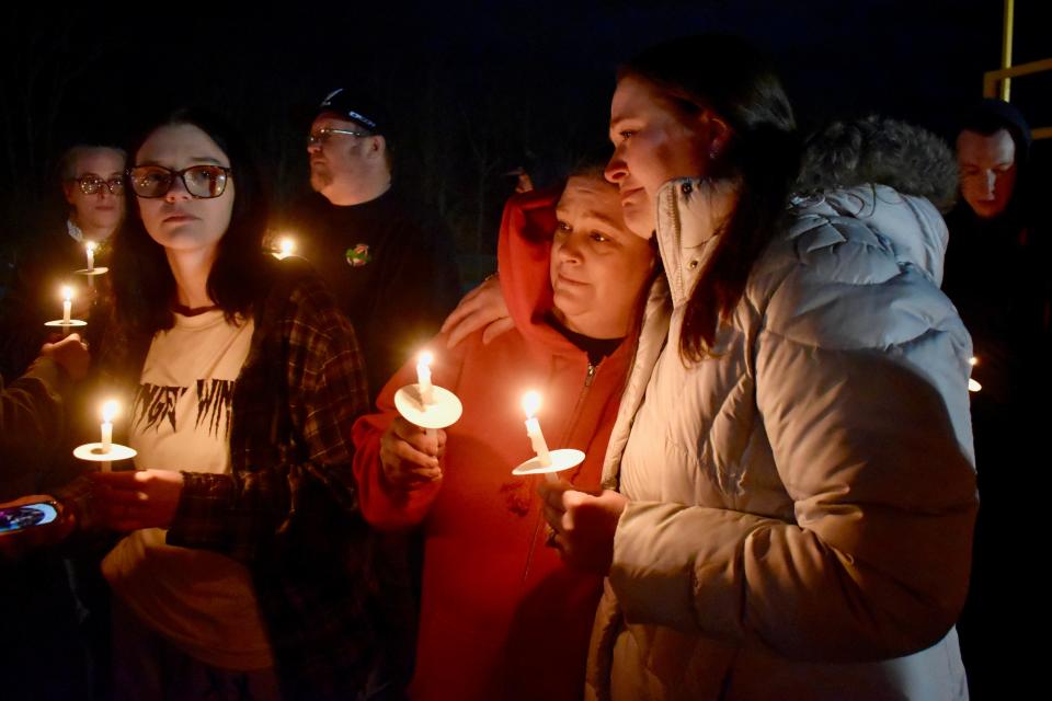 Christine Loveless, center, cries on the shoulder of a family member during a candlelight vigil at the Harpursville Central School football field Thursday for her son, 13-year-old Brennan, who died from his injuries after being struck by a vehicle New Year's Day.