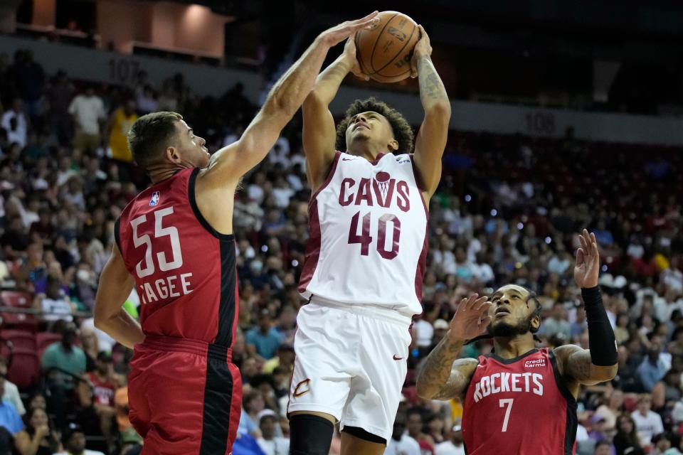 Houston Rockets' Fletcher Magee, left, fouls Cleveland Cavaliers' Craig Porter during the first half of the NBA summer league championship game July 17 in Las Vegas.