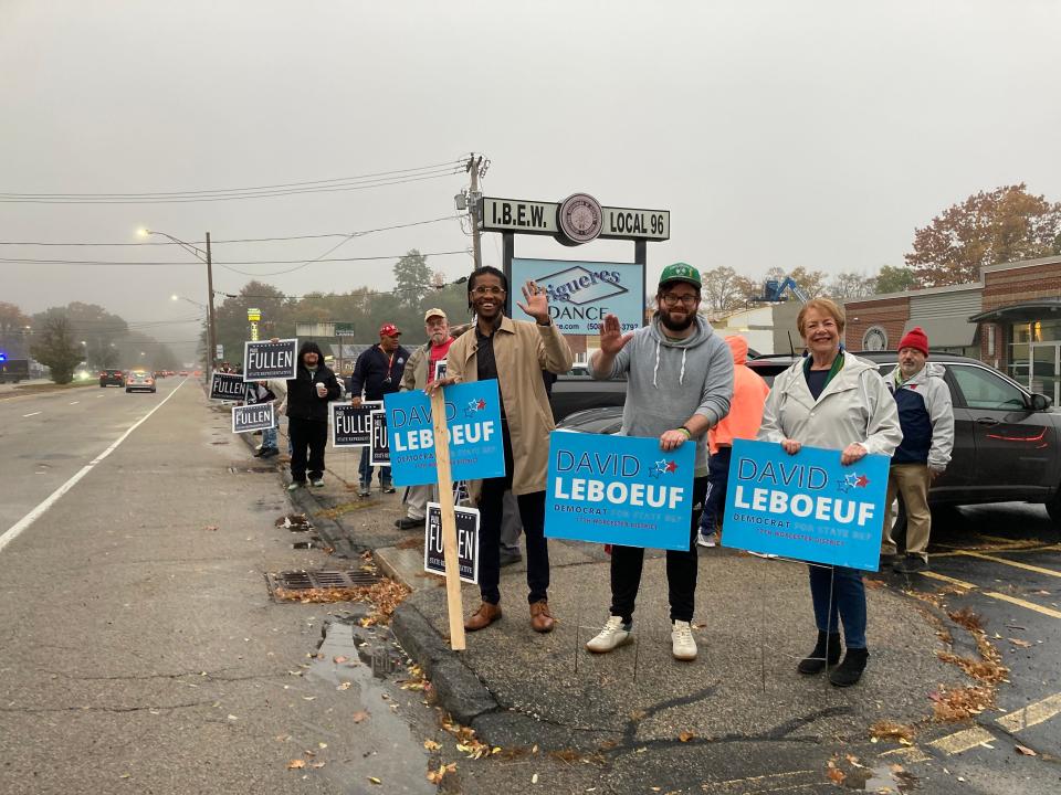 Sign holders supporting local candidates vying for the House in the 17th Worcester District were dressed for the weather before the start of the debate between incumbent Democrat David LeBoeuf and challenger Republican Paul Fullen.