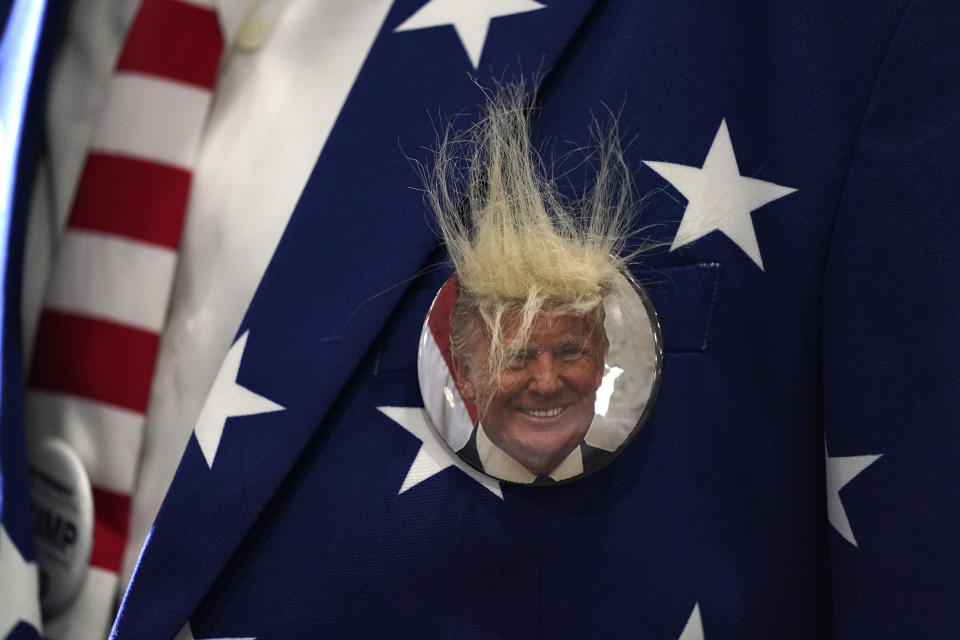 A supporter wears a campaign button as he waits for President Donald Trump to speak at a rally at Xtreme Manufacturing, Sunday, Sept. 13, 2020, in Henderson, Nev. (AP Photo/Andrew Harnik)