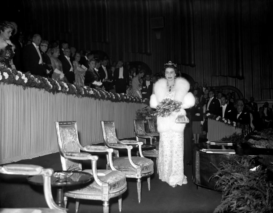 Queen Elizabeth II about to take her seat in the Royal box at the Odeon, Leicester Square for the Royal Film Performance of MGM’s ‘Les Girls’.