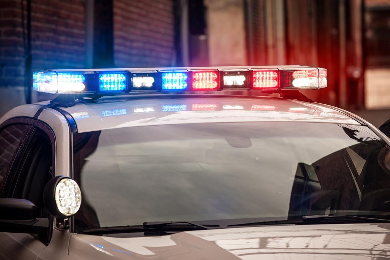 Modern LED light bar on police cruiser flashing red and blue emergency lights.