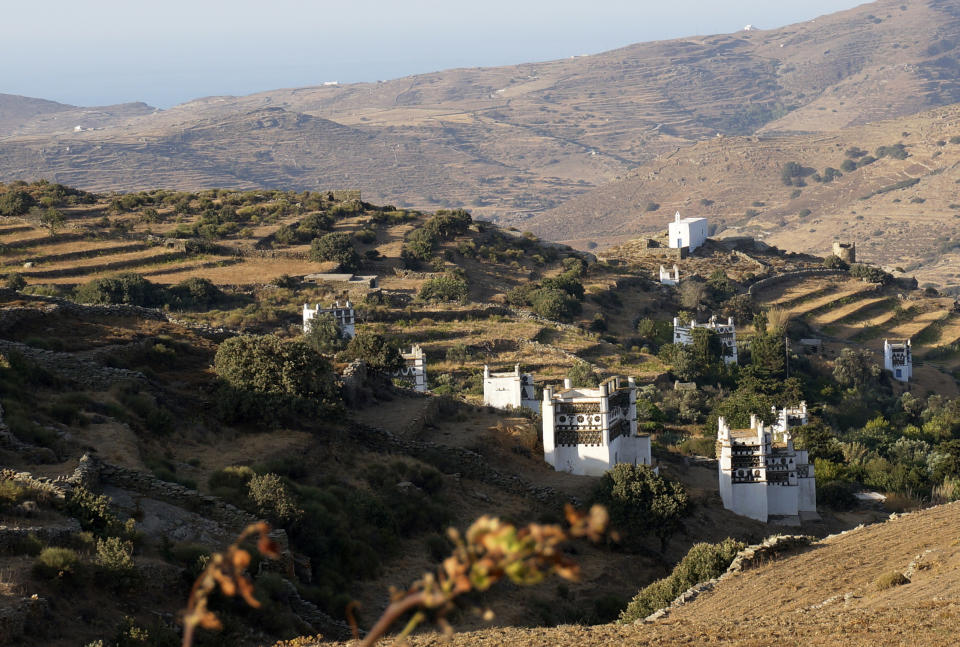 A profusion of dovecotes built like fantastically carved towers dots the countryside among stonewalled terraces in Tinos island, Greece, on August 27, 2021. The Cycladic island has many marble-decorated villages linked by remote mountain roads. (AP Photo/Giovanna Dell’Orto)