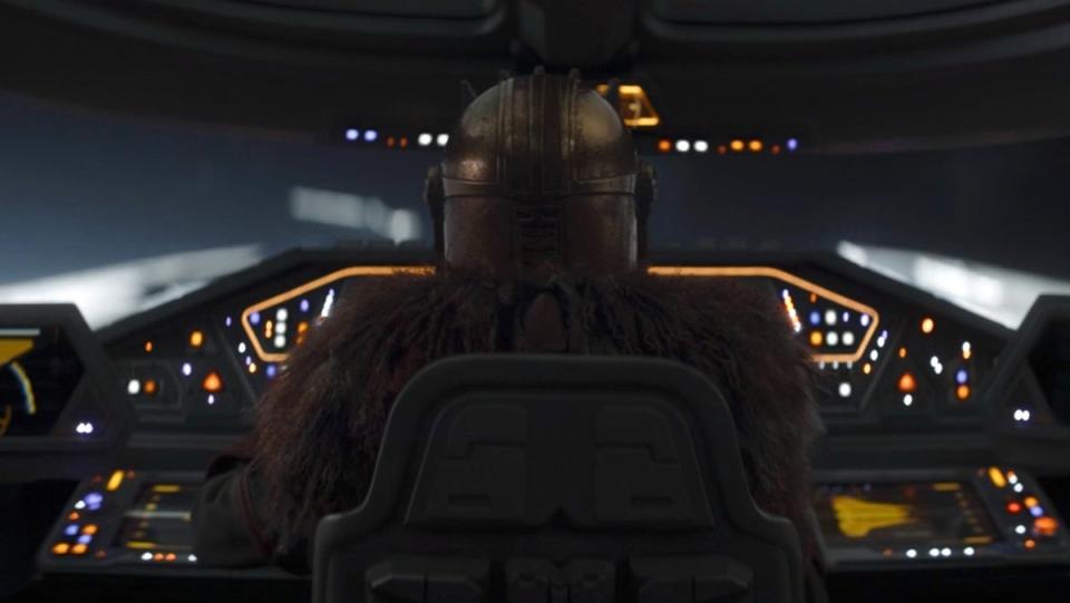 The back of the Armorer's head as she flies a ship on The Mandalorian