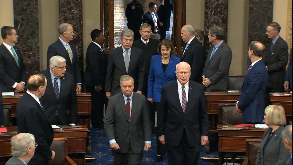 In this image from video, Sen. Lindsey Graham, R-S.C., left, Sen. Patrick Leahy, D-Vt., Sen. Dianne Feinstein, D-Calif., and Sen. Roy Blunt, R-Mo., escort Supreme Court Chief Justice John Roberts into the Senate chamber in the Senate at the U.S. Capitol in Washington, Thursday, Jan. 16, 2020. (Senate Television via AP)