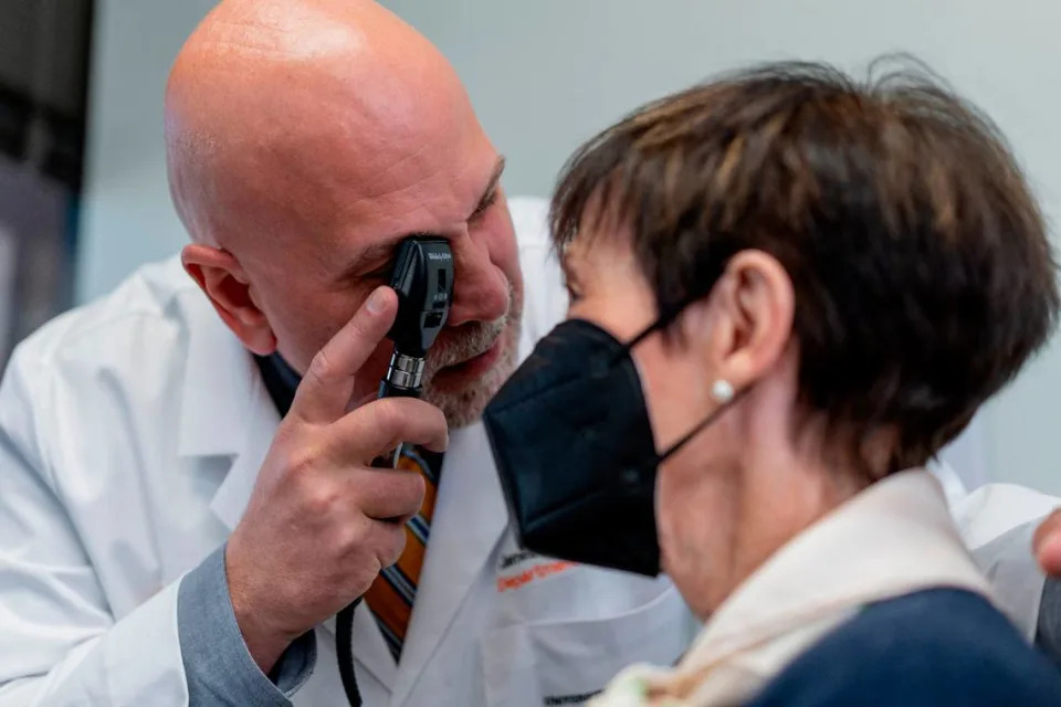 Dr. James Galvin, the director of UM’s Comprehensive Center for Brain Health, examines a patient.