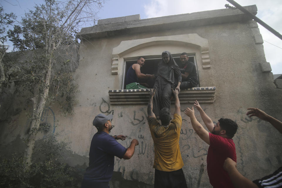 Palestinians evacuate building hit n the Israeli bombardment of the Gaza Strip in Rafah, Sunday, Oct. 22, 2023. (AP Photo/Hatem Ali)