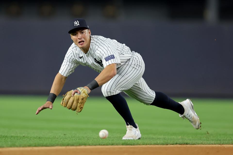 Aug 3, 2023; Bronx, New York, USA; New York Yankees shortstop Anthony Volpe (11) dives for a ground ball by Houston Astros catcher Martin Maldonado (not pictured) during the fifth inning at Yankee Stadium.