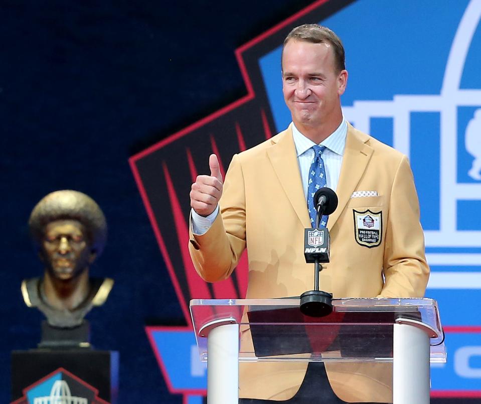 Peyton Manning is enshrined in the Pro Football Hall of Fame at Tom Benson Hall of Fame Stadium on Aug. 8, 2021. Manning was presented by his father, Archie Manning.