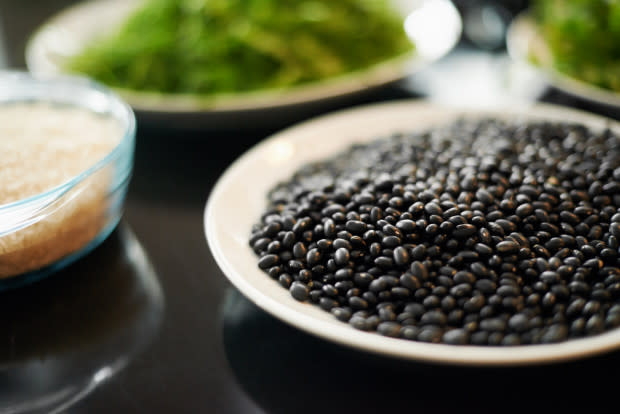 <p>One cup of black beans contains nearly five grams of soluble fiber, which binds to cholesterol in the digestive tract and removes cholesterol from the body. Black beans are also rich in anthocyanins, an antioxidant that helps protect the heart. </p><p>“Beans figure prominently in all of the Blue Zone diets,” Katz says, meaning diets in regions of the world where heart disease affects just a small fraction of people as compared to those on the standard American diet. </p><p>So in place of meat from the burrito bar, opt for heart-healthy black beans. Toss beans into salads and breakfast scrambles, or make your own <a href="http://www.michelledudash.com/2013/02/27/quinoa-and-black-bean-cakes-with-cumin-chile/" rel="nofollow noopener" target="_blank" data-ylk="slk:quinoa patties;elm:context_link;itc:0;sec:content-canvas" class="link ">quinoa patties</a>.</p>
