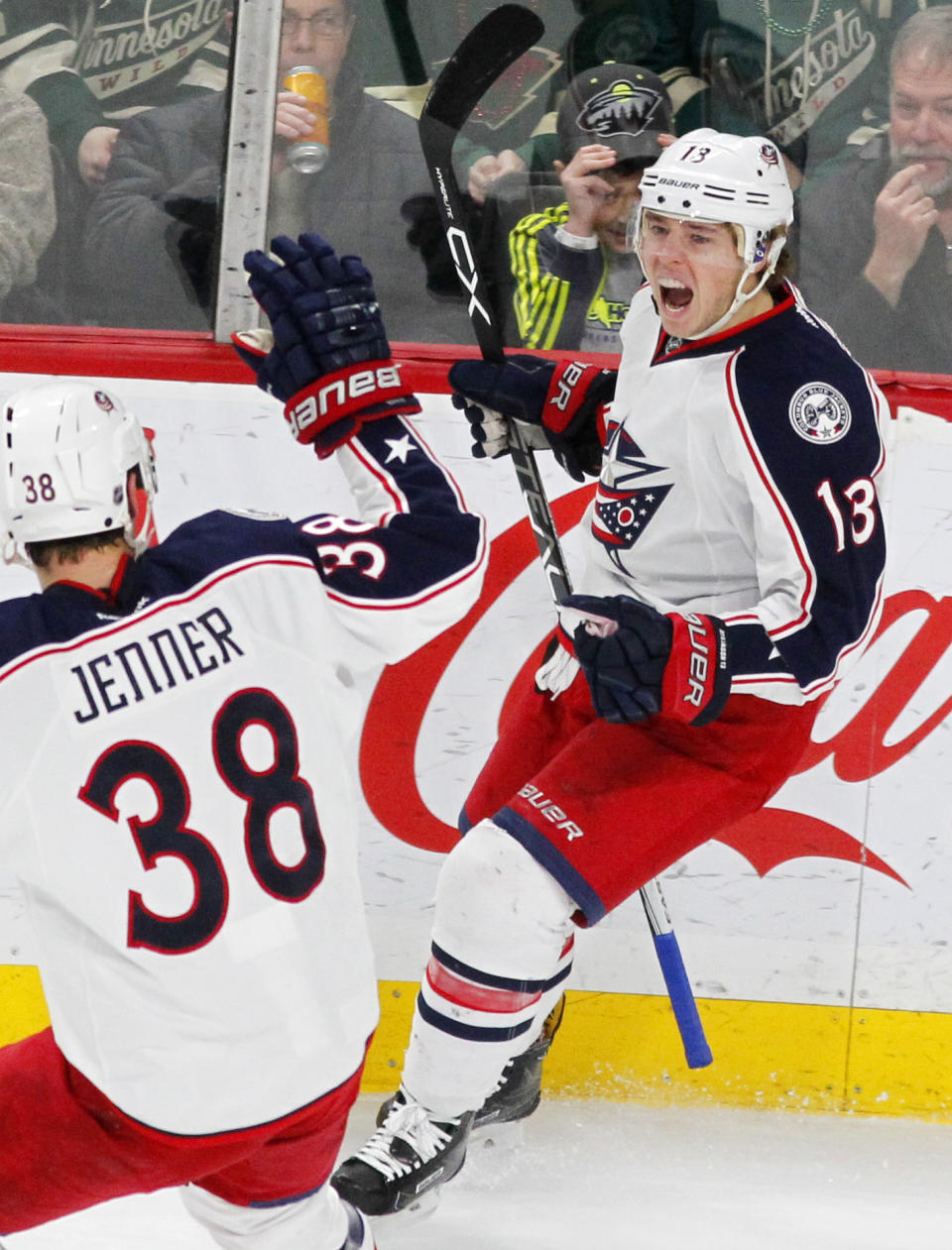 Columbus Blue Jackets right wing Cam Atkinson (13) celebrates his goal with teammate Boone Jenner (38) against the Minnesota Wild during the first period of an NHL hockey game Saturday, Dec. 31, 2016, in St. Paul, Minn.(AP Photo/Andy Clayton-King)