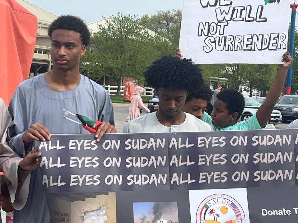 Sudanese community members protest violence in Sudan during Eid al Fitr prayers April 21 at the Ohio Expo Center.