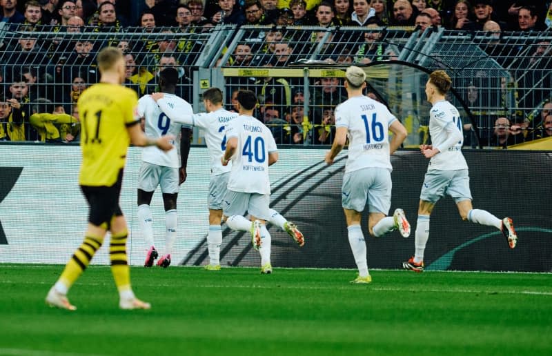 Hoffenheim's Ihlas Bebou of (2nd L) celebrates scoring his side's first goal with teammates during the German Bundesliga soccer match between Borussia Dortmund and TSG 1899 Hoffenheim at Signal Iduna Park. Bernd Thissen/dpa