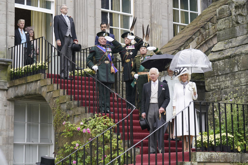 FILE - Britain's King Charles III, Queen Camilla and Princess Anne, background, host guests for a Garden Party at the Palace of Holyroodhouse, in Edinburgh, Tuesday, July 4, 2023. Two months after the lavish coronation of King Charles III at Westminster Abbey in London, Scotland is set to host its own event to mark the new monarch’s accession to the throne. While Charles won’t have a separate coronation Wednesday in Edinburgh, the festivities will include a crown, horse-drawn carriages, mounted cavalry and a flyover by the Red Arrows. (Jonathan Brady/Pool Photo via AP, File)