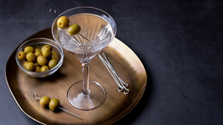 martini with bowl of olives