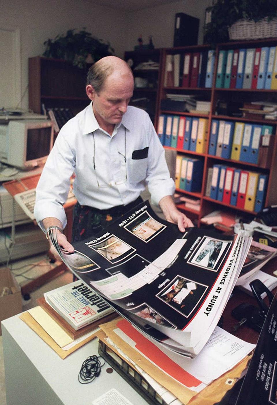 Attorney Robert Blasier looks over evidence photographs in his Sacramento home office on Oct. 4, 1995, the day after the not guilty verdict in the O.J. Simpson trial. Dick Schmidt/Sacramento Bee file