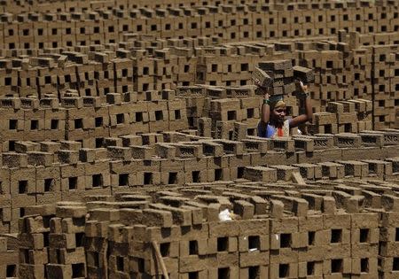 A labourer carries bricks at a kiln in Karjat, India, March 10, 2016. REUTERS/Danish Siddiqui