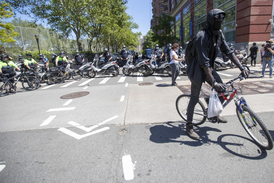 The police block 111th Street to keep protesters from reaching the FDR during a solidarity rally for George Floyd, Saturday, May 30, 2020, in New York. Floyd died after Minneapolis police officer Derek Chauvin pressed his knee into his neck for several minutes even after he stopped moving and pleading for air. (AP Photo/Mary Altaffer)