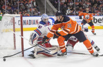 New York Rangers goalie Alexandar Georgiev (40) makes a saveagainst Edmonton Oilers' Zach Hyman (18) during second-period NHL hockey game action in Edmonton, Alberta, Friday, Nov. 5, 2021. (Jason Franson/The Canadian Press via AP)