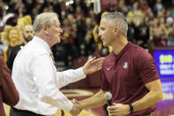 Florida State's new head football coach Mike Norvell, right, greets Florid State president John Thrasher during half time of an NCAA college basketball game against Clemson in Tallahassee, Fla., Sunday, Dec. 8, 2019. (AP Photo/Mark Wallheiser)