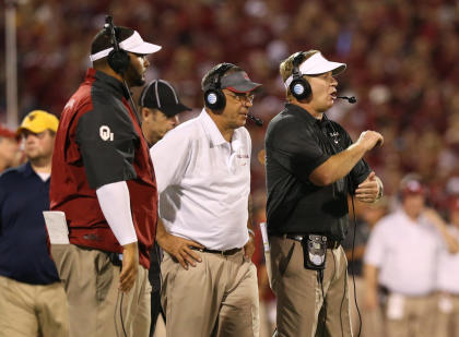 Sep 7, 2013; Norman, OK, USA; Oklahoma Sooners defensive coordinator Mike Stoops (right) linebacker coach Tim Kish (center) and defensive line coach Jerry Montgomery during the game against the West Virginia Mountaineers at Gaylord Family - Oklahoma Memorial Stadium. (Matthew Emmons-USA TODAY Sports)