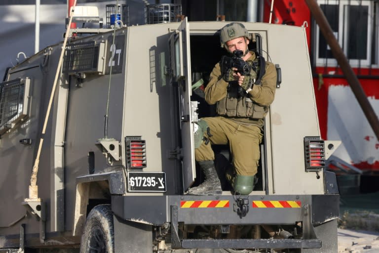 An Israeli soldier aims his rifle during a raid on the Nur Shams refugee camp in the occupied West Bank (JAAFAR ASHTIYEH)