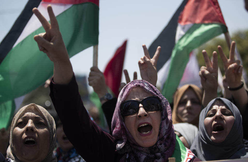 Palestinian women chant slogans and flash the victory sign as they demonstrate against Israeli plans for the annexation of parts of the West Bank, in Gaza City, Wednesday, July 1, 2020. (AP Photo/Khalil Hamra)