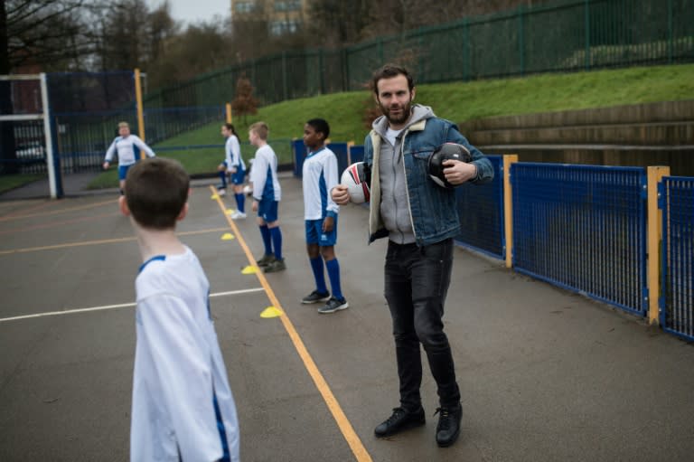 Juan Mata joins in football activities with pupils during a visit through the Manchester United Foundation to Beever Primary School in Oldham, northwest England on February 19, 2018