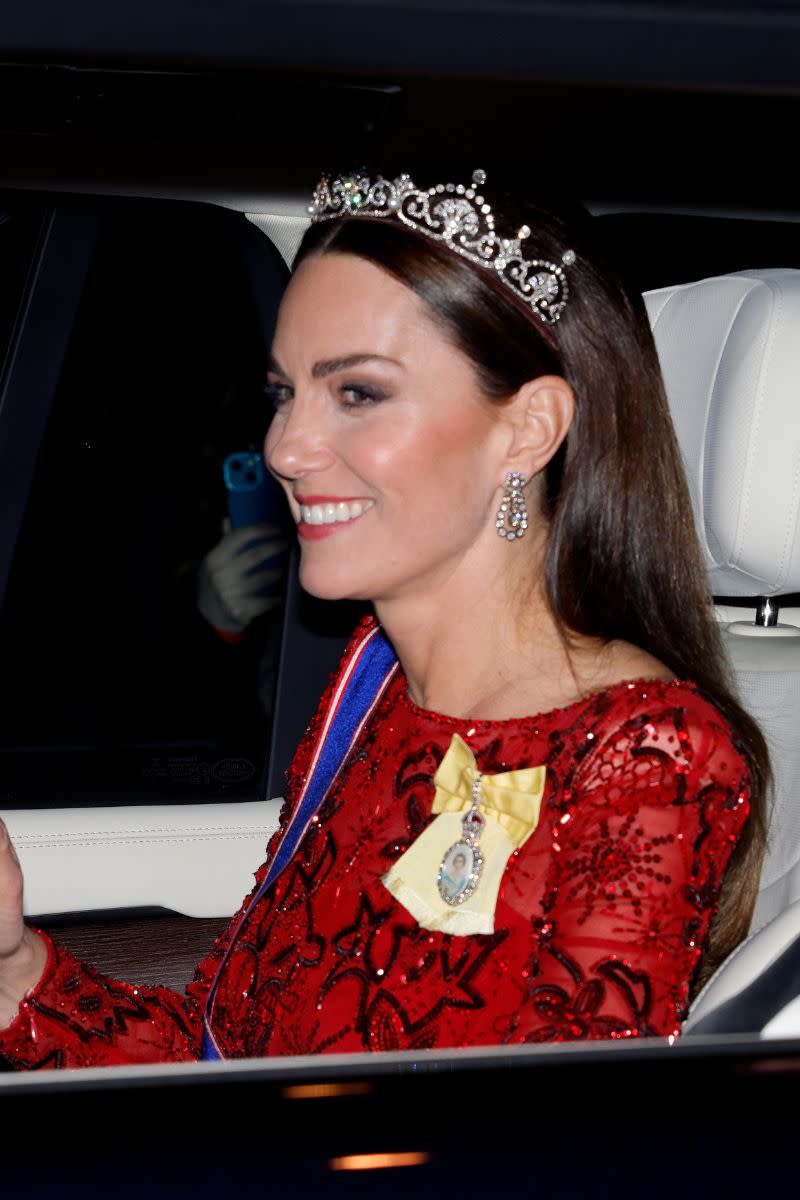 <p> A suitably regal hairstyle, this smoothed-back middle parted look lets the sparkly tiara be the centre of attention. Tucking the hair behind the ears not only opens up Kate's face, but it also works to add extra thickness to the back of the head that prevents this straight style from falling too flat. A foolproof and elegant style, it is one of our favourites. </p>
