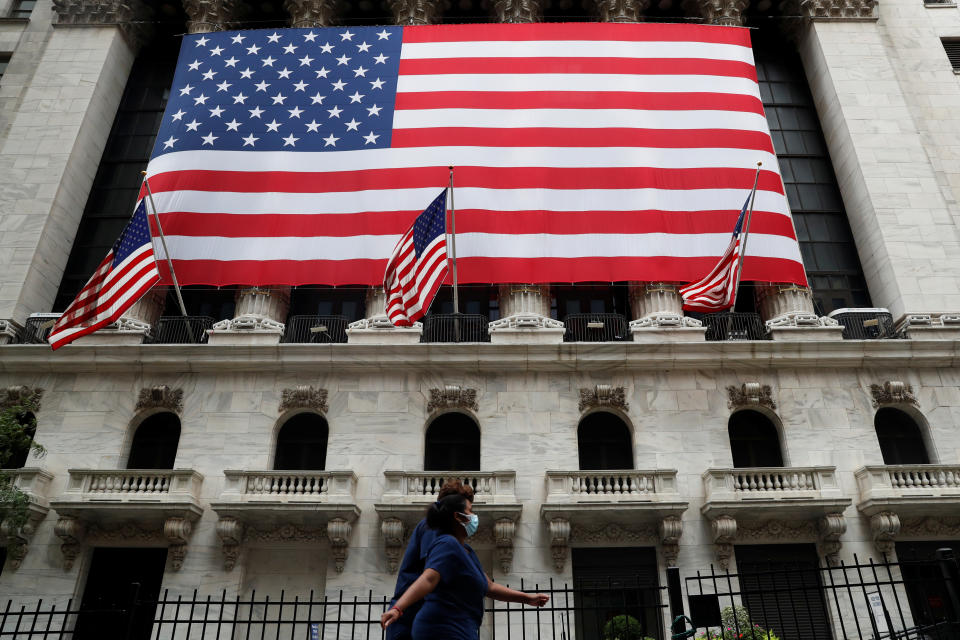 Health care workers walk with protective face masks on past the New York Stock Exchange, amid the coronavirus disease (COVID-19) pandemic, in the lower section of Manhattan in New York City, U.S., September 9, 2020.   REUTERS/Shannon Stapleton