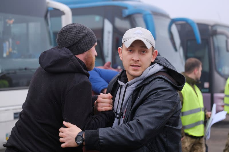 Men board buses for pro-Russian rebels during prisoner of war exchange in Donetsk region