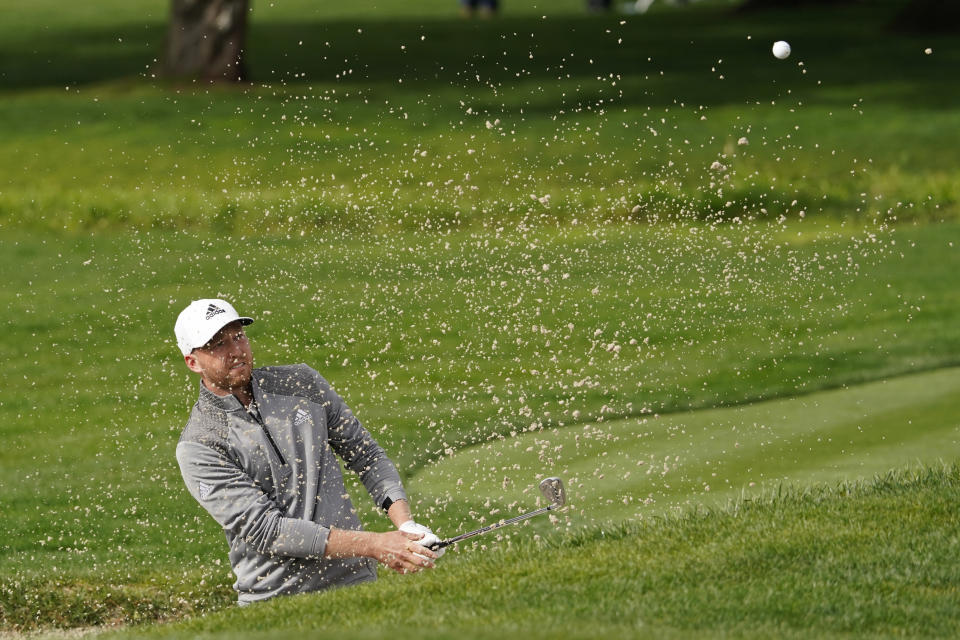 Daniel Berger follows his shot out of a bunker onto the second green of the Pebble Beach Golf Links during the third round of the AT&T Pebble Beach Pro-Am golf tournament Saturday, Feb. 13, 2021, in Pebble Beach, Calif. (AP Photo/Eric Risberg)