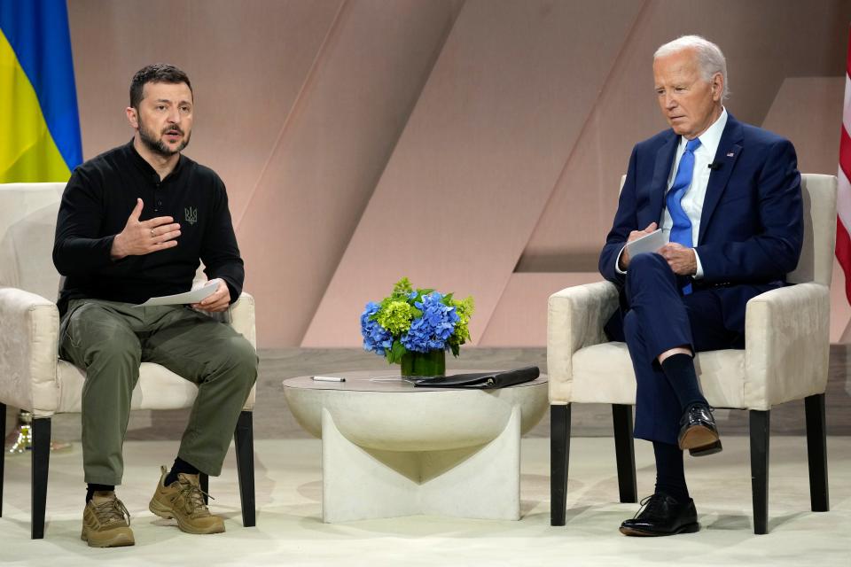 Ukraine's President Volodymyr Zelenskyy speaks as President Joe Biden listens in a NATO summit meeting.