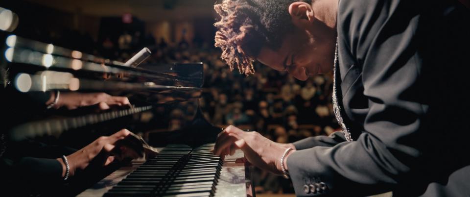 Jon Batiste disappears into his symphonic composition while performing at Carnegie Hall in the documentary "American Symphony."