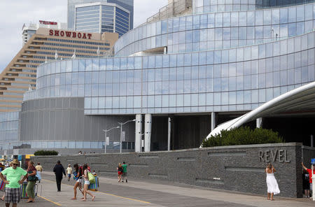 People walk outside the Revel Casino Hotel in Atlantic City, New Jersey September 1, 2014. REUTERS/Tom Mihalek