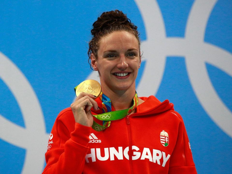 Katinka Hosszu holds up a gold medal at the Rio Olympics.