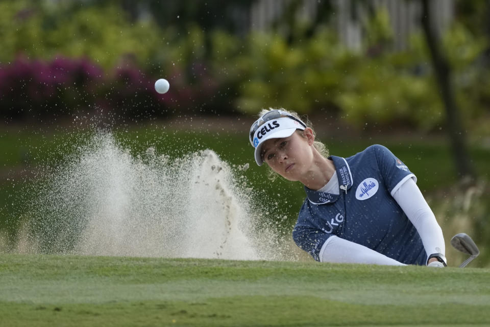Nelly Korda, of the United States, hits out of a greenside bunker on the 16th hole during the third round of the LPGA Tour Championship golf tournament, Saturday, Nov. 20, 2021, in Naples, Fla. (AP Photo/Rebecca Blackwell)