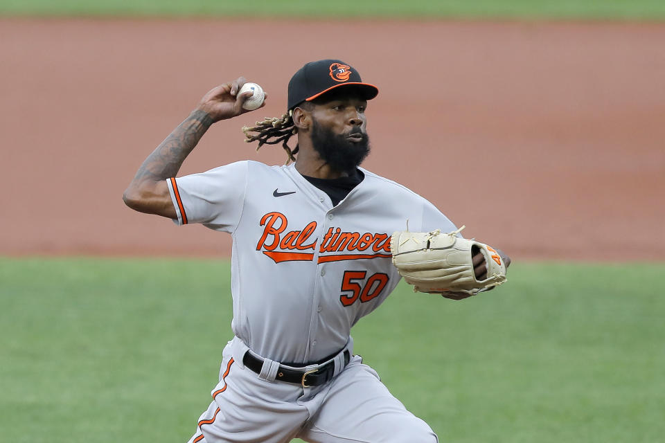 Baltimore Orioles relief pitcher Miguel Castro throws a pitch to the Washington Nationals during the seventh inning in the continuation of a suspended baseball game, Friday, Aug. 14, 2020, in Baltimore. The first part of the game was suspended on Aug. 9, when the groundskeepers had technical difficulties with the infield tarp in the sixth inning during a rain delay, causing the infield to become too wet and muddy to play. (AP Photo/Julio Cortez)